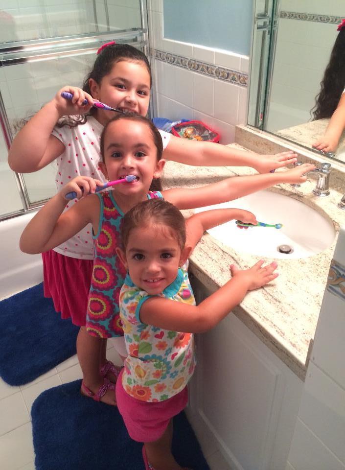 Girls Brushing Teeth With Faucet Off